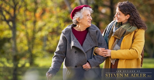 Adult daughter on a walk with her elderly mother